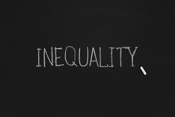 Obraz premium Word Inequality written on black board, panorama