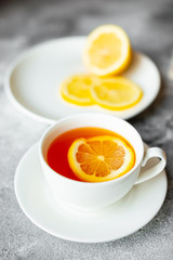 Tea, lemon, hot, drink. Tasty fragrant hot tea with a lemon on a concrete background