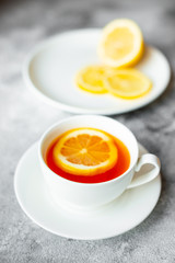 Tea, lemon, hot, drink. Tasty fragrant hot tea with a lemon on a concrete background