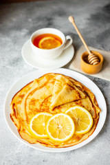 Food, dessert, pastries, pancake, pie. Tasty beautiful pancakes with banana and honey on a concrete background