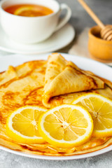 Food, dessert, pastries, pancake, pie. Tasty beautiful pancakes with banana and honey on a concrete background
