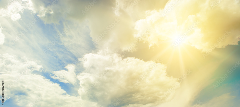 Wall mural Sun on blue sky with white clouds.