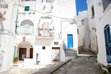 Narrow streets of Ostuni town with white buildings, Puglia, Italy
