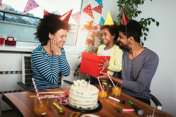 Happy family celebrating a birthday together at home