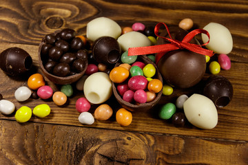 Easter composition with chocolate eggs on wooden background