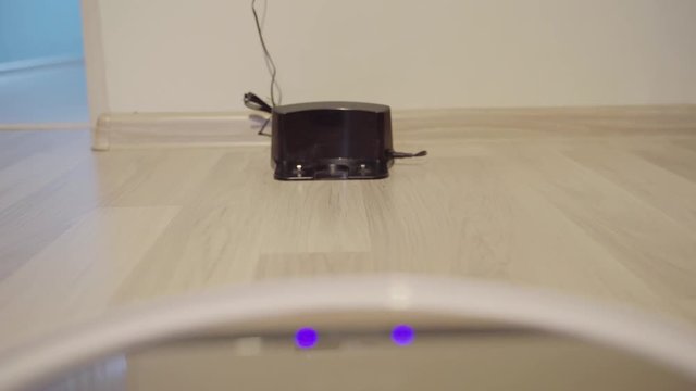 Automatic Vacuum Robot Cleaning going to charge station.