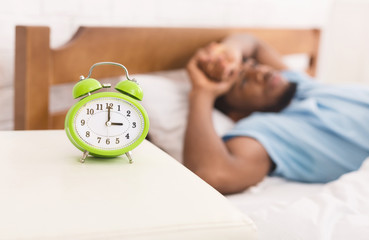 Black man in bed suffering from insomnia and sleep disorder