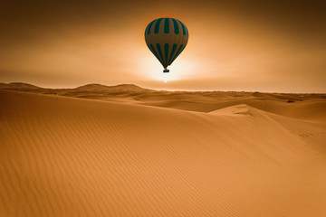 Obraz na płótnie Canvas Desert and hot air balloon Landscape at Sunrise.