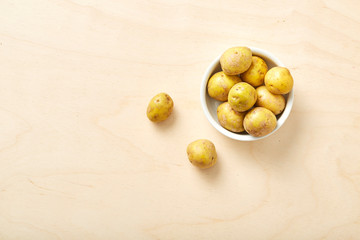 Fototapeta na wymiar Raw potato on wooden table.