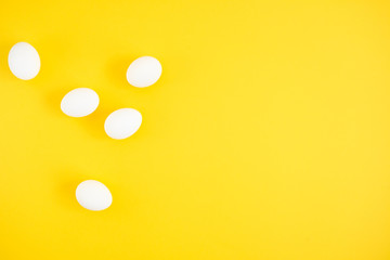 White eggs on yellow background