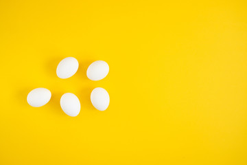 White eggs on yellow background