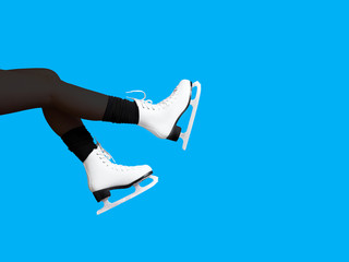Ice skating, skater, female feet in skates shoes isolated on blue background, ice rink. Winter time. Girl, winter sports, copy space