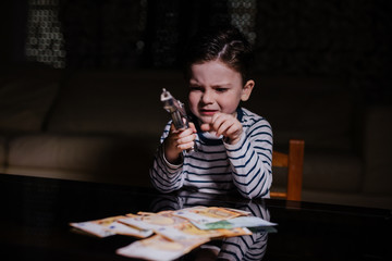 Little mobster with gun and money on the table 