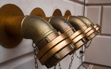 Four vintage fire hydrants on the facade of a European building. Germany. Berlin