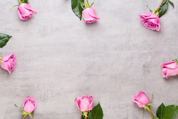 Flowers valentine day composition. Frame made of pink rose on gray background. Flat lay, top view, copy space.