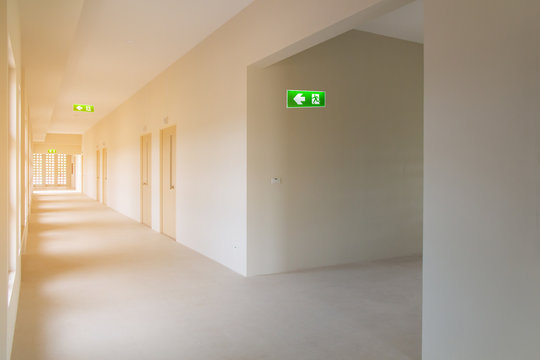 green emergency exit sign to install in new hospital building construction showing the way to escape