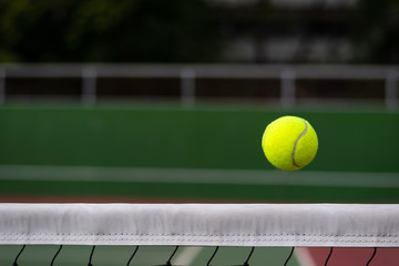 Close up tennis ball on the net background with copy space
