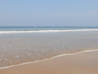 Obraz premium Morning surf on the sandy beach and white waves are splashing