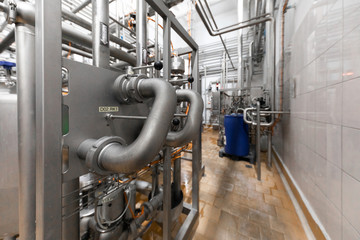 Industrial zone background concept. Steel pipelines and cables in manufacture interior