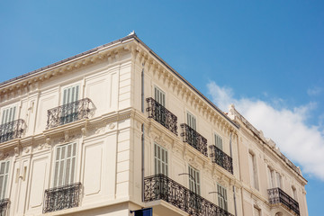 Close up of corner of old white facade building during sunny day, Cannes France