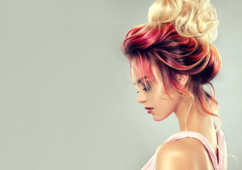 Beautiful model girl  with elegant  multi colored hairstyle . Stylish Woman with fashion  hair  color highlighting.   Creative  red and pink roots ,   trendy  coloring. 
 - obrazy, fototapety, plakaty