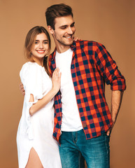 Portrait of Smiling Beautiful Girl and her Handsome Boyfriend laughing.Happy Cheerful Family.Valentine's Day. Posing on beige wall. Hugging