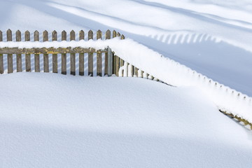 snow-covered wooden fence