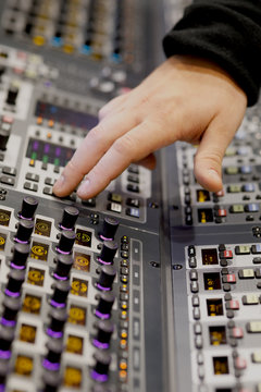 sound engineer working on music mixer console