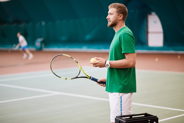 Indoor Tennis match which a serving male player of european appearance