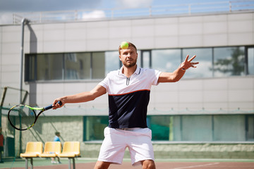 Tennis match which a serving player practicing devastating serve on outdoor training