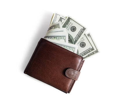 Brown leather wallet with dollars on white paper background. Flat lay.