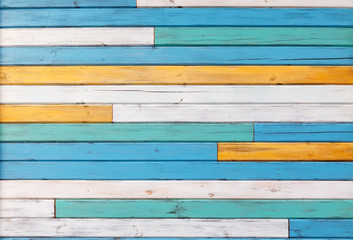 Surface of the old boards painted in white, yellow and blue