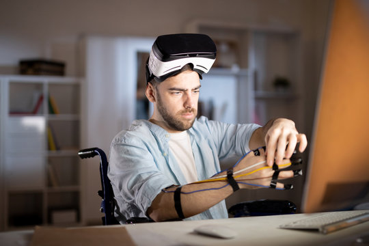 Businessman with vr headset putting sensors on his fingers before traveling in virtual reality