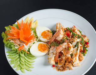 Spicy and sour seafood salad mixed with vegetables,  Thai herbs and boiled eggs ,shrimp,squid in Thai style