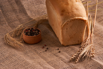 loaf of bread, concept of home food close up on sacking background
