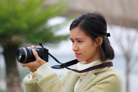 woman taking picture with mirrorless camera