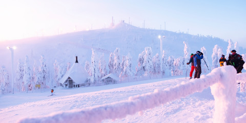 Morning at the ski resort.Kuusamo Ruka. Finland. Skiers and snowboarders glide down the mountain...