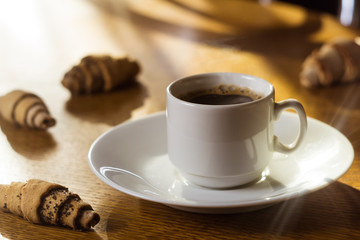 coffee cup with cookies. Blurred background. Morning coffee. White cup.