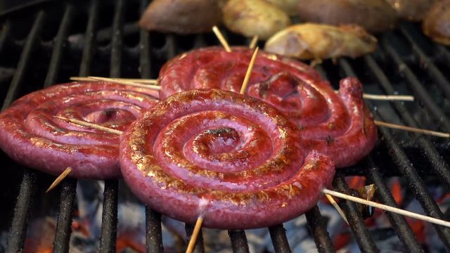 Sausages rolls on skewers grilled. HD video