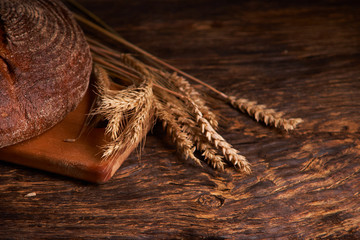 Top view of wholegrain bread on dark ructic wooden background closeup