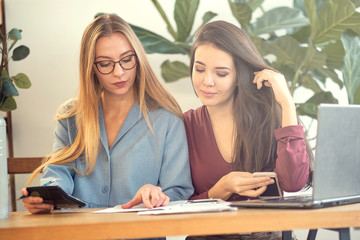 two young girls work in a beautiful green office. ecology and ergonomics in the office. comfortable environment to increase employee efficiency.