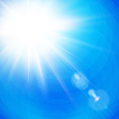 Fototapeta premium Vivid Sunburst with radiating rays in a clear blue sky.