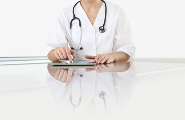hands of doctor woman touch digital tablet at office desk isolated on white background