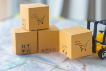 Mini forklift truck load cardboard box with text online shopping and symbols on street map. Logistics and transportation management ideas and Industry business commercial concept.