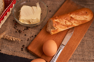 Bakery - gold rustic crusty loaves of bread and buns on black chalkboard background. Still life captured from above