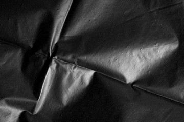 Abstract background crumpled plastic film texture black garbage bag