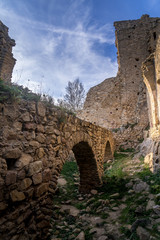 Naklejka premium View of Palafolls castle medieval ruined stronghold between Girona and Barcelona on the Costa Brava with the Catalan flag proudly flying over the Romanesque church