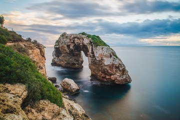 Es Pontas Beautiful Natural Arch on Mallorca Island seen at sunrise