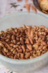 Cup full of hazelnuts picked from the garden.