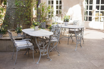 Cafe, coffee shop, tavern and restaurant concept - Outdoor street cafe tables ready for service.